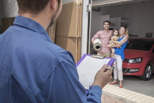 Furniture pick-up team handling bulky items in a Holland Park residential street
