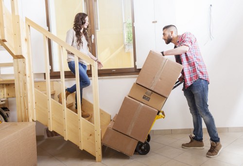 Packed boxes and furniture ready for a local move in Holland Park