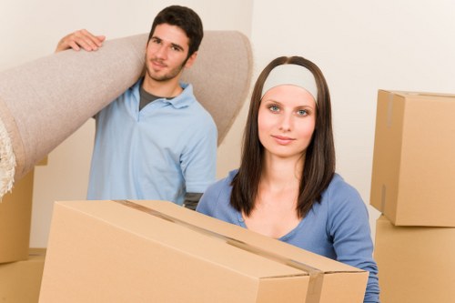 Packed household boxes and furniture prepared for a local move in Holland Park