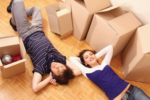 Professional moving team handling furniture on a quiet Holland Park street