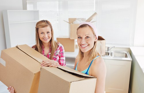 Packed moving boxes and protected furniture ready for transport