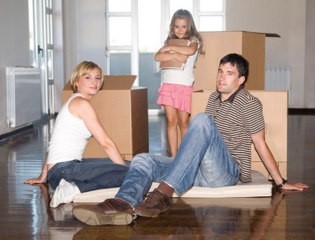 Loading household furniture into a removal van for a Holland Park home move
